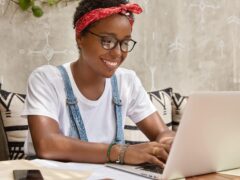 stylish-businesswoman-works-laptop-computer-cozy-coffee-shop-keyboards-information-min-2048x1365