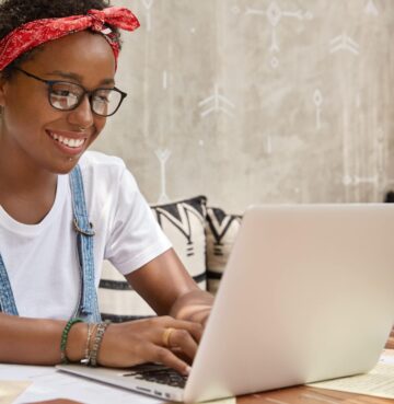 stylish-businesswoman-works-laptop-computer-cozy-coffee-shop-keyboards-information-min-2048x1365